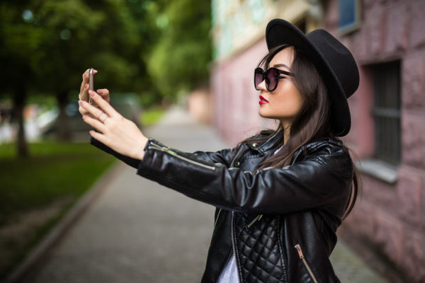 attractive-young-asian-girl-making-selfie-her-smart-phone-street